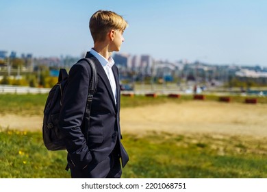 Handsome Teenager 15-18 Years Old Male High School Student. Smiling Teenage Boy With School Bag On The Way To College.