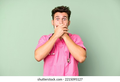 Handsome Teenager Covering Mouth With Hands With A Shocked. Nurse Concept