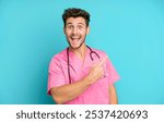 handsome teenager looking excited and surprised pointing to the side. nurse concept