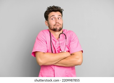 Handsome Teenager Shrugging, Feeling Confused And Uncertain. Nurse Concept