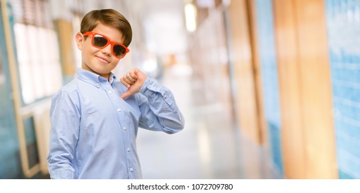 Handsome Toddler Child With Green Eyes Proud, Excited And Arrogant, Pointing With Victory Face At School Corridor