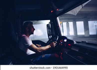 Handsome Truck Driver At Work. Night Shift.