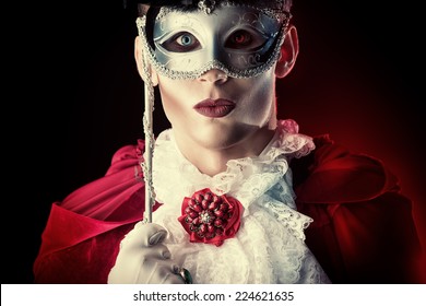 Handsome Vampire Wearing Venetian Mask. Halloween Carnival. Dracula Costume.