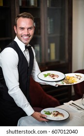 Handsome Waiter Serving Meal In A Fancy Restaurant