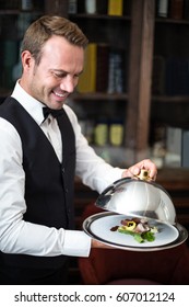 Handsome Waiter Serving Meal In A Fancy Restaurant