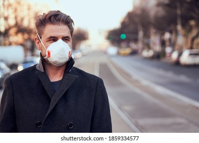 Handsome White Middle Aged Man Wearing Medical Face Mask While Walking Down The Street.