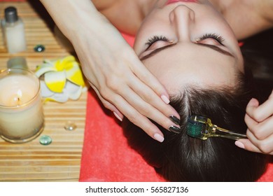 Handsome woman receives an injection in the head. The concept of mesotherapy. Thrust to strengthen the hair and their growth. Girl is getting injection in head. Concept of Mesotherapy. Mezoroller