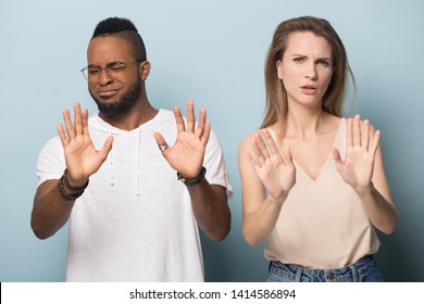 Handsome Young African American Man In Eyeglasses And Millennial Caucasian Woman Denying, Rejecting Proposition, Refusing Bad Deal Offer, Disagree With Possible Scam, Diverse Family Couple Saying No