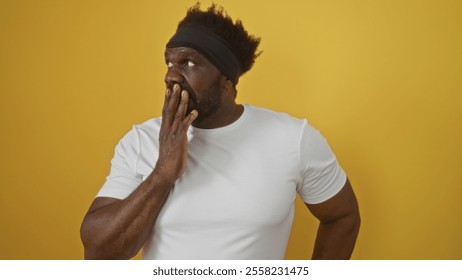 Handsome young african american man with a beard in a white shirt stands over an isolated yellow background, appearing thoughtful and pensive. - Powered by Shutterstock