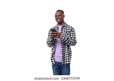 handsome young african man dressed in a plaid shirt talking on the phone - Powered by Shutterstock