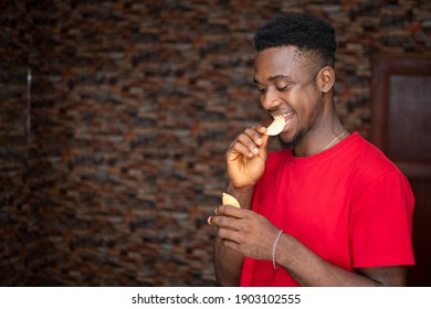 Handsome Young African Man Eating Chips