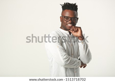 handsome young african man in glasses and white shirt on a white background
