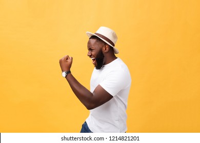 Handsome Young Afro-American Man Employee Feeling Excited, Gesturing Actively, Keeping Fists Clenched, Exclaiming Joyfully With Mouth Wide Opened, Happy With Good Luck Or Promotion At Work