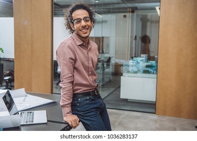 handsome young architect leaning back on workplace at office - Shutterstock ID 1036283137