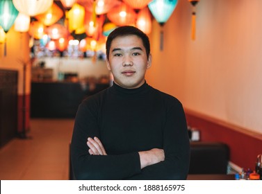 Handsome Young Asian Man In Black Clothes In Festive Chinese Vietnamese Restaurant With Colorful Paper Lanterns, Small Own Business