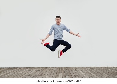 Handsome Young Asian Man Jumping In The Street