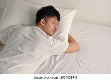 Handsome Young Asian Man Sleeping In Bed