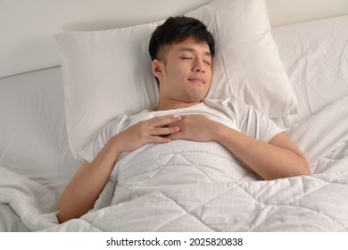 Handsome Young Asian Man Sleeping In Bed