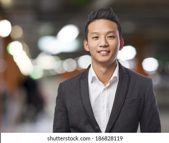 handsome young asian man standing wearing a suit