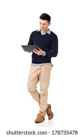 Handsome Young Asian Man Using Pad, Full Length Portrait Isolated On White Background.