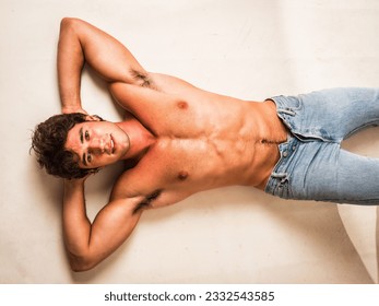 Handsome young bodybuilder laying down on the floor - Powered by Shutterstock