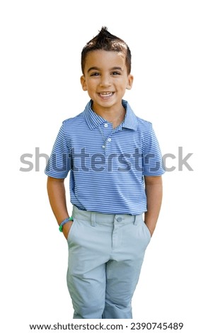 A handsome young boy dressed in nice golf clothing for formal attire smiles with hands in pockets and mohawk hair style with gel