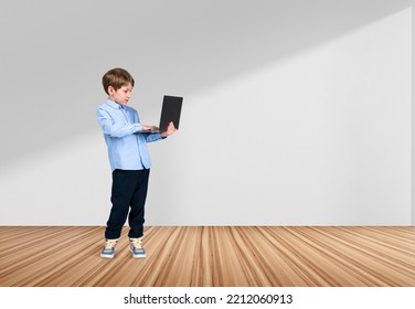 Handsome young boy wearing formal wear is standing holding laptop near empty white wall in background. Wooden hardwood floor. Concept of modern gadgets, learning, studying, progressive kids - Shutterstock ID 2212060913