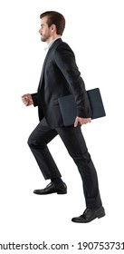 Handsome Young Business Man Go Walk Making Step, Businessman Wear Elegant Black Suit And And Holding A Laptop Or Folder. Isolated Over White Background