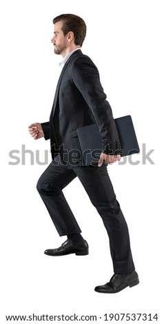 Handsome young business man go walk making step, businessman wear elegant black suit and and holding a laptop or folder. isolated over white background