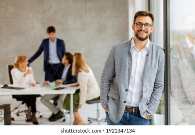 Handsome Young Business Man Standing Confident In The Office In Front Of His Team