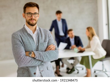 Handsome Young Business Man Standing Confident In The Office In Front Of His Team