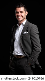 Handsome Young Business Man Standing On Black Background