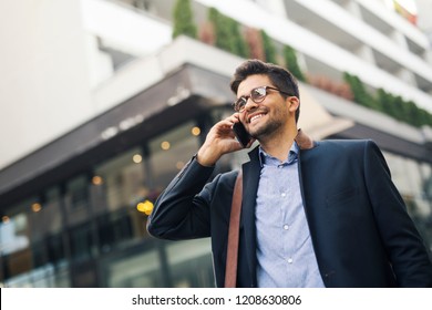 Handsome young businessman talking on mobile phone - Powered by Shutterstock