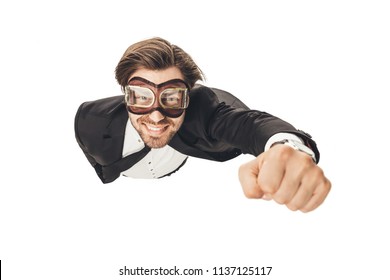 handsome young businessman in vintage aviation goggles flying like superhero isolated on white - Powered by Shutterstock