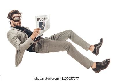 handsome young businessman in vintage aviation goggles reading newspaper while falling isolated on white - Powered by Shutterstock