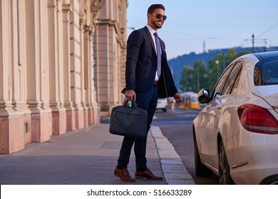 A Handsome Young Businessman Walking To His Car
