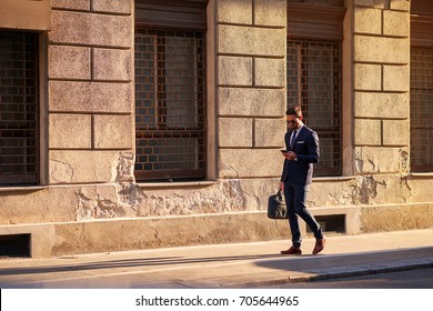 A handsome young businessman walking on the street in the sunset
 - Powered by Shutterstock