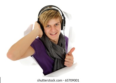 Handsome Young Caucasian Man With Headset Breaking Through A Paper Wall, Gesturing Thumb Up. Copy Space. Studio Shot. White Background.