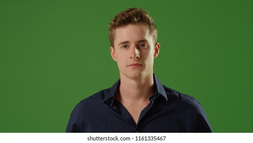 Handsome young Caucasian man looking at camera on green screen - Powered by Shutterstock