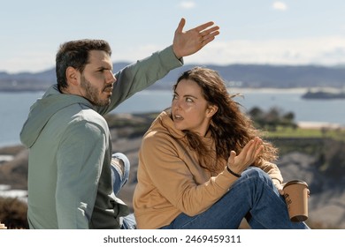 handsome young couple argue in a park by the beach, couple crisis, teenagers, divorce - Powered by Shutterstock