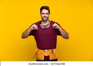 Handsome Young Craftsman Over Isolated Yellow Background Proud And Self-satisfied