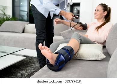 Handsome Young Doctor Visiting A Woman Patient At Home