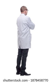 Handsome young doctor wearing glasses with arms crossed on white background