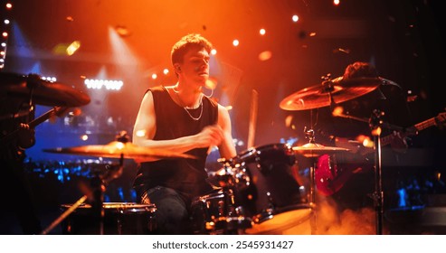 Handsome Young Drummer Performing on Concert Stage with His Band Members, Surrounded by Falling Confetti and Pulsating Visuals. Young Musicians Showcasing Their Skills and Energy. Slow Motion Footage - Powered by Shutterstock