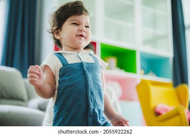 Handsome Young Father Playing With Little Child Daughter Who Is Climbing Stairs At Home And Man Motivating Her To Come Upstairs