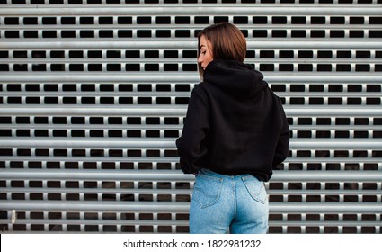 Handsome Young Female Wearing Black Blank Hoodie With Space For Your Logo Or Design. Mockup For Print