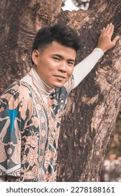 A handsome young Filipino man wearing an ethnic tribal inspired boho outfit at a nature park. - Shutterstock ID 2278188161