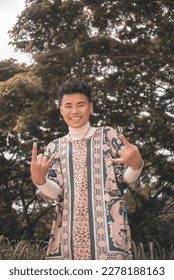 A handsome young Filipino man wearing an ethnic tribal inspired boho outfit at a nature park. - Shutterstock ID 2278188163