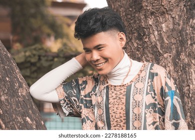 A handsome young Filipino man wearing an ethnic tribal inspired boho outfit at a nature park. - Shutterstock ID 2278188165