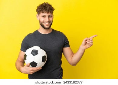 Handsome young football player man isolated on yellow background pointing finger to the side - Powered by Shutterstock